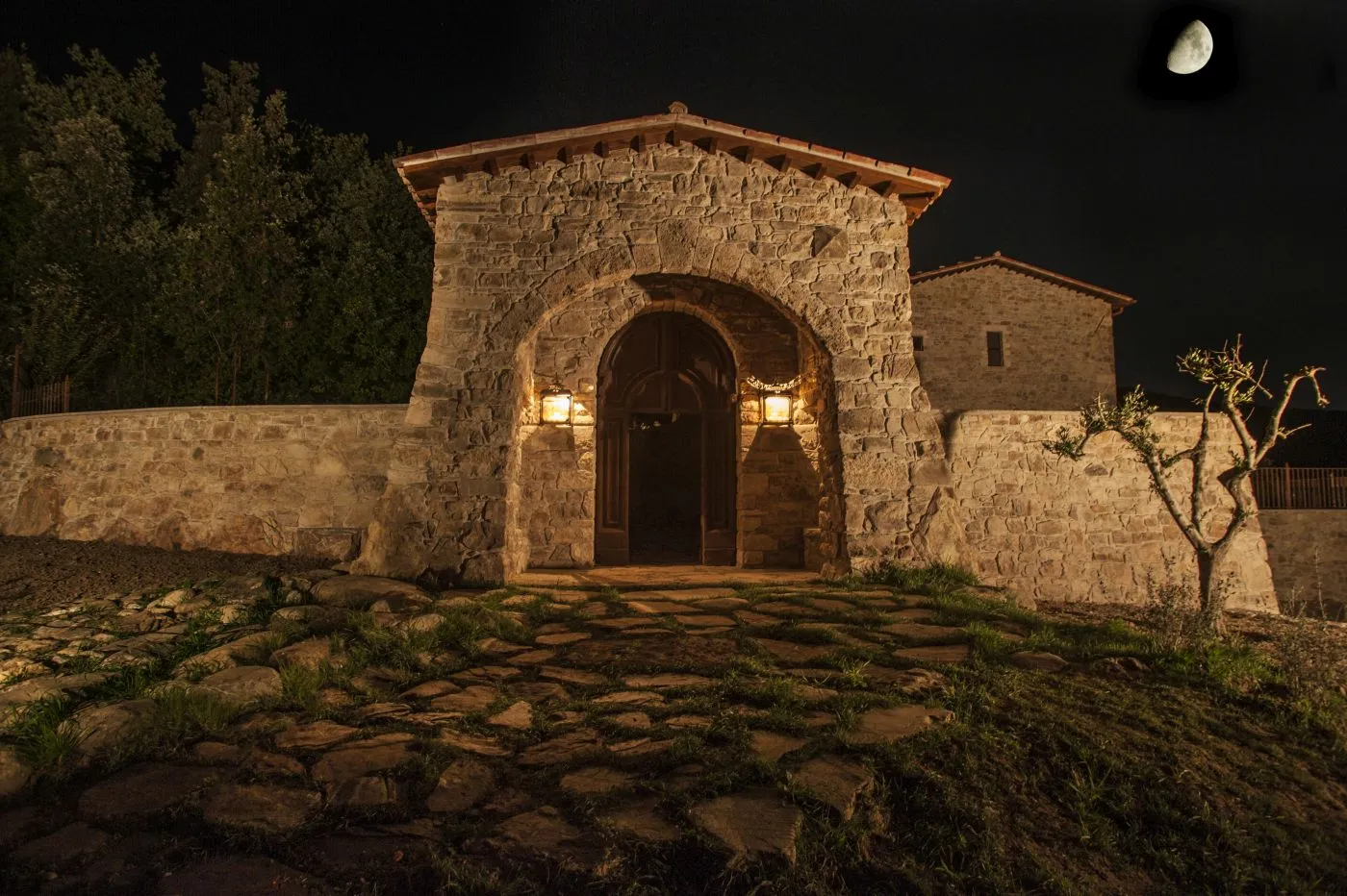 Monastery entrance at night under moonlight