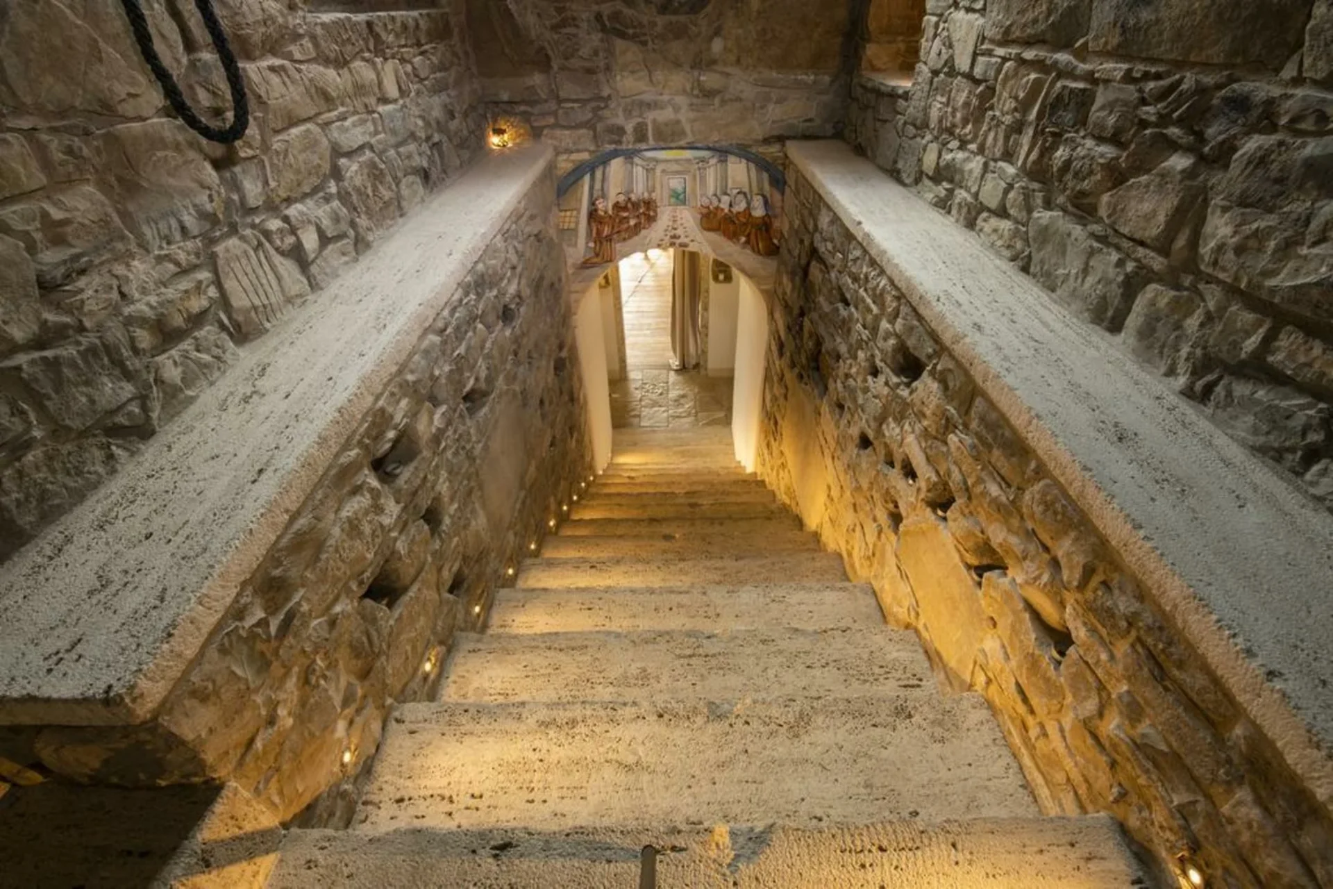 Ancient stone stairway descending into the monastery